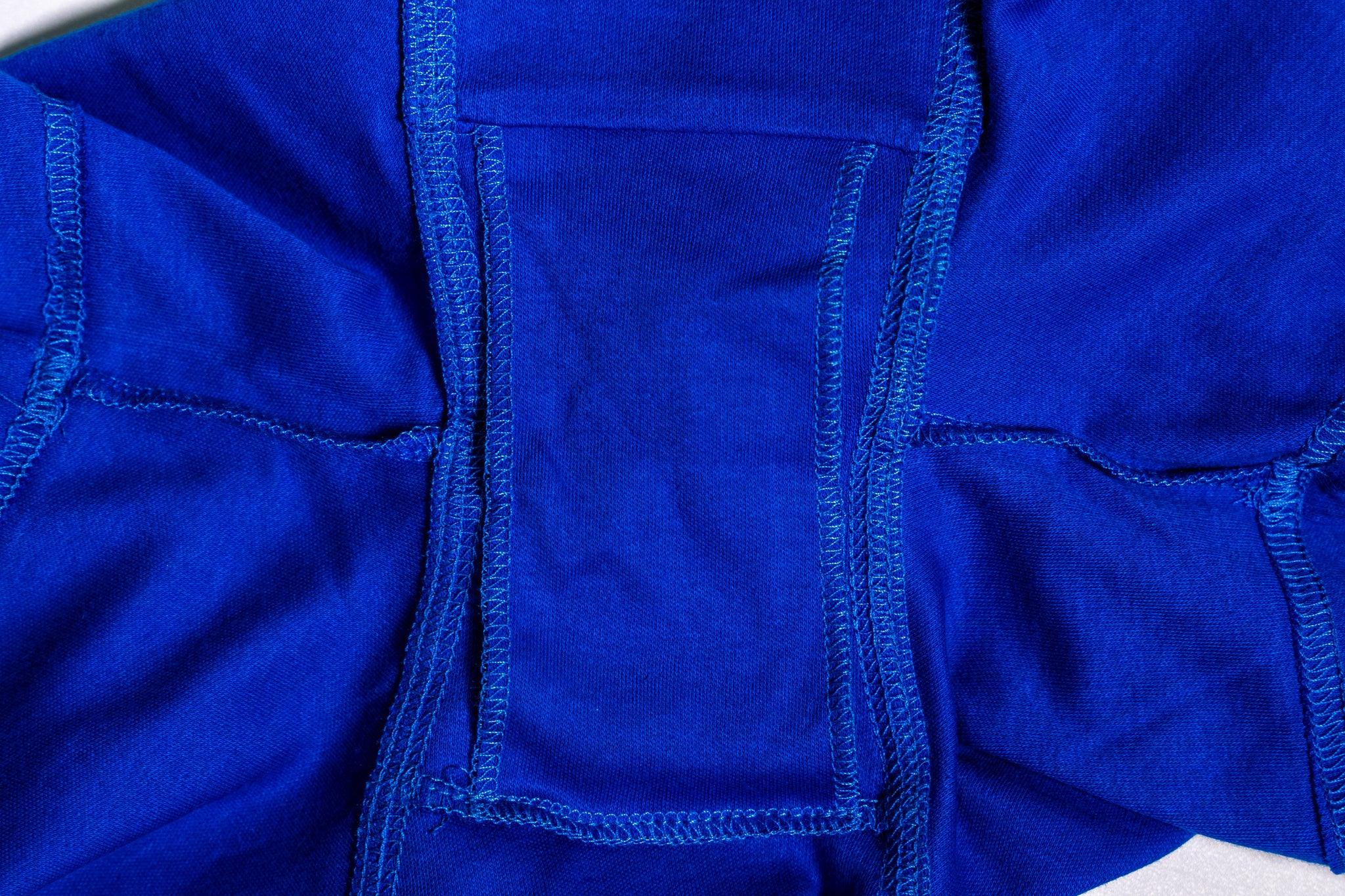 Close-up of a blue fabric with stitching detail